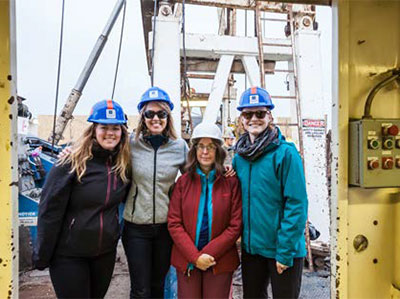 Graduate students visit a geothermal drill rig with GBCGE Director,
Bridget Ayling.